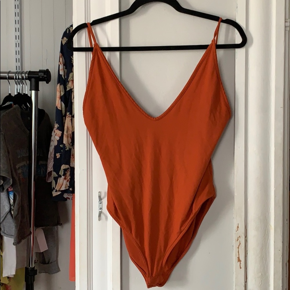 burnt orange body suit